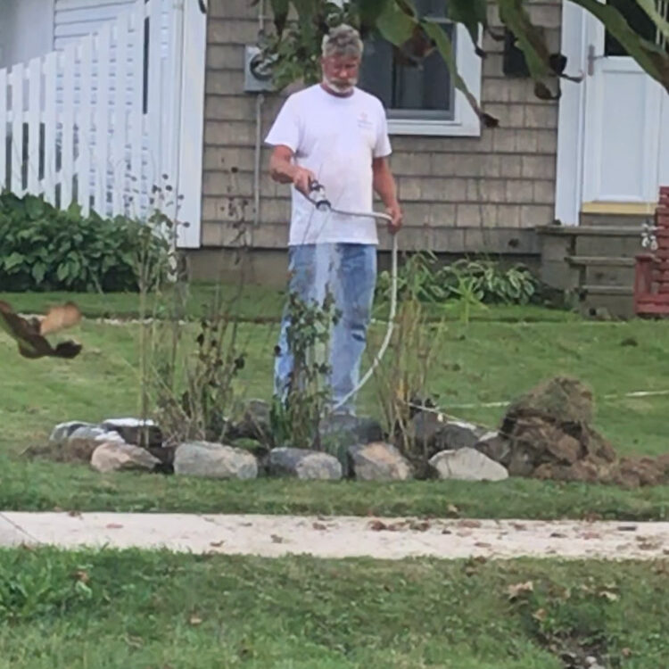 Mark watering his new small native plant section